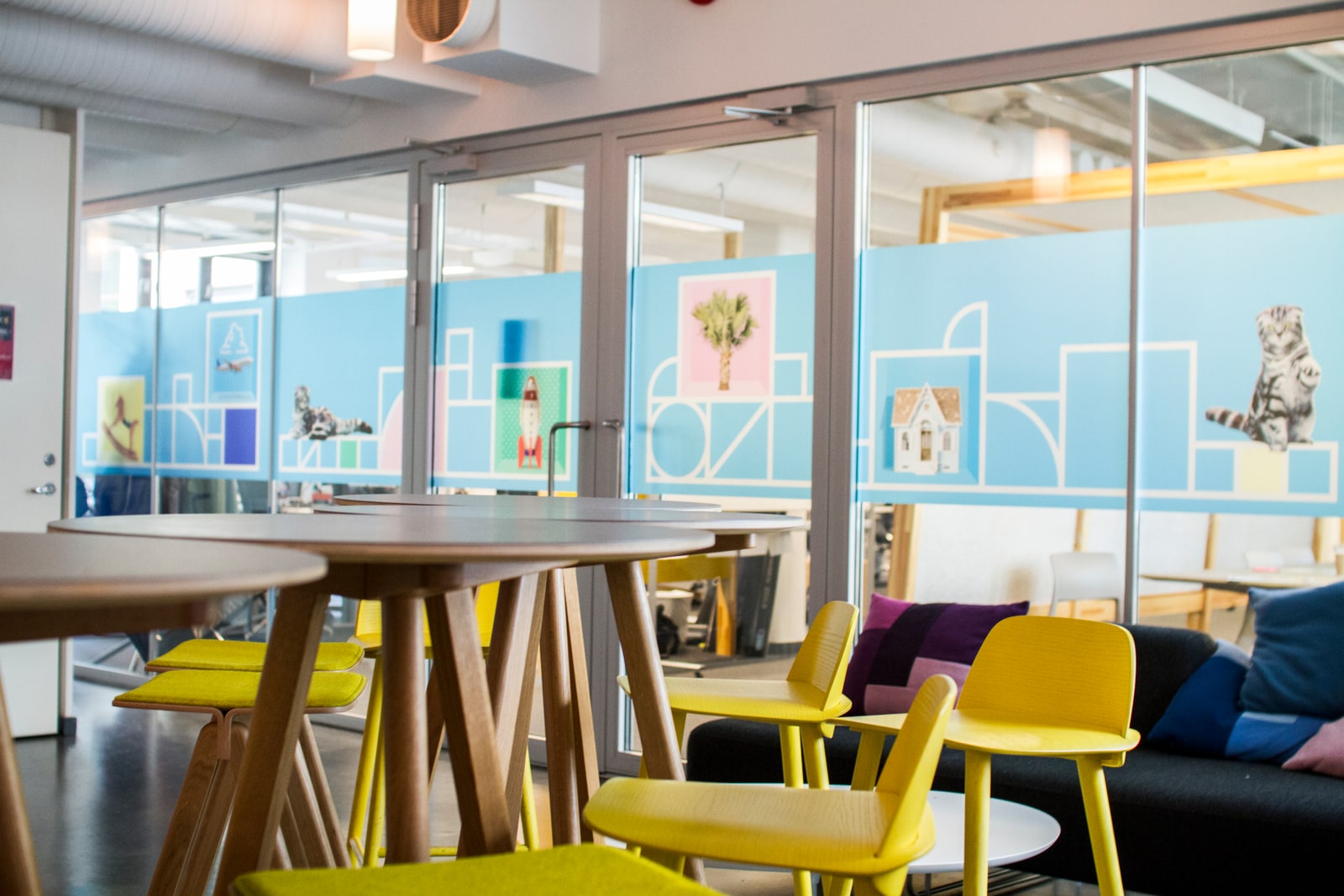 FINN office interior with colorful chairs and illustrated partitions
