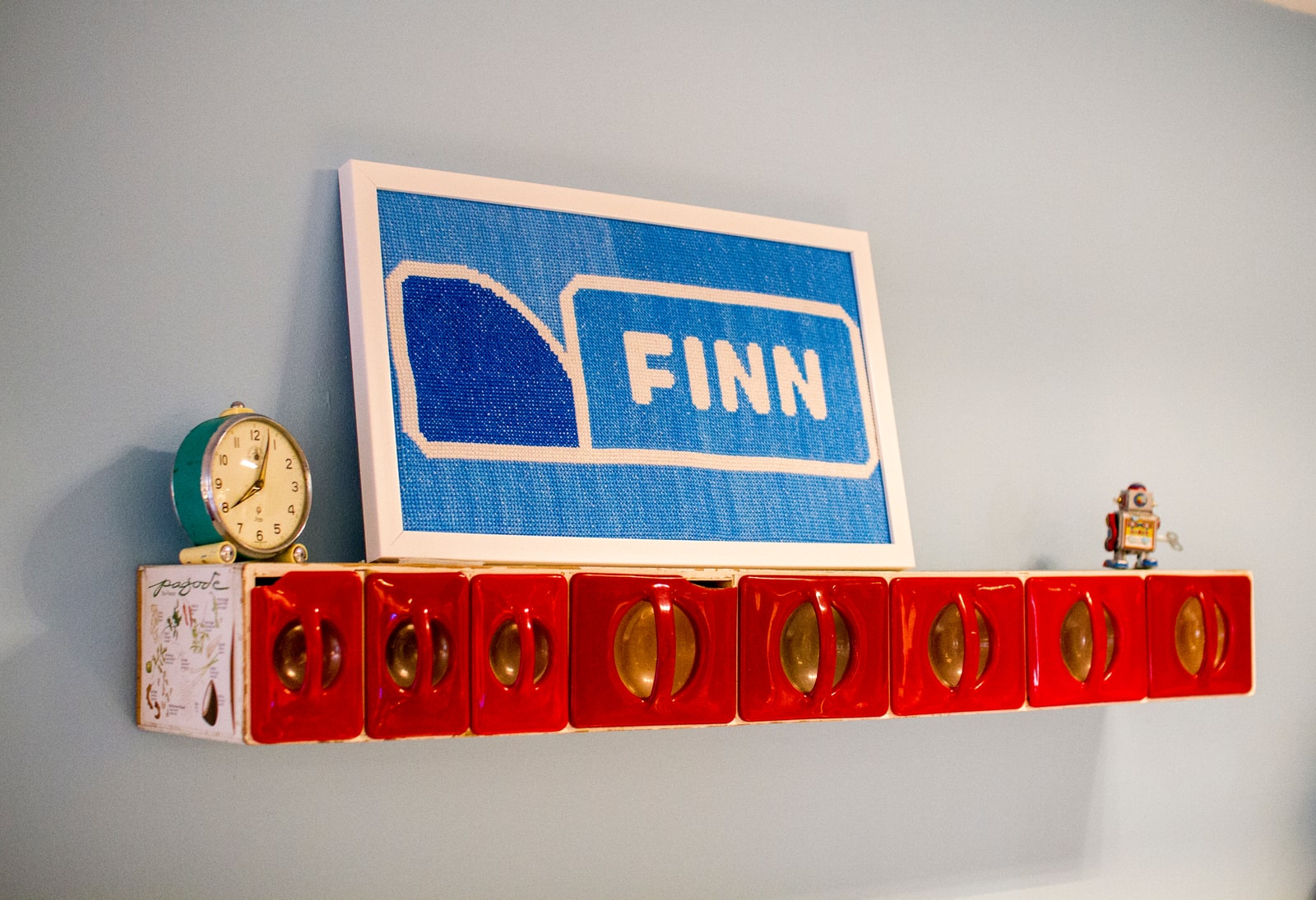 FINN sign above a red wall-mounted coat rack